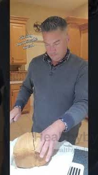 Heath slicing a loaf of homemade sourdough bread